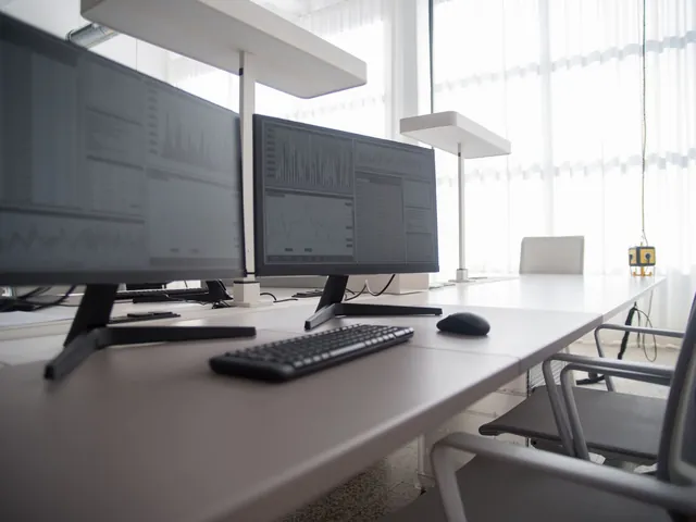 Bright workstation with screens showing market charts