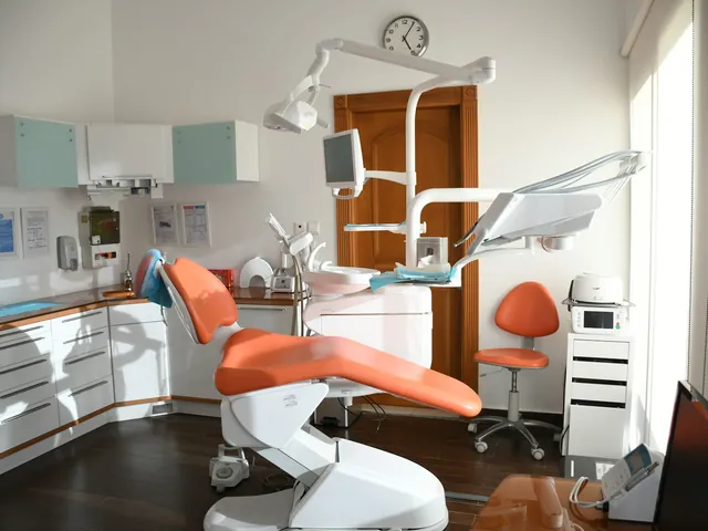 Bright dental surgery with an orange treatment chair